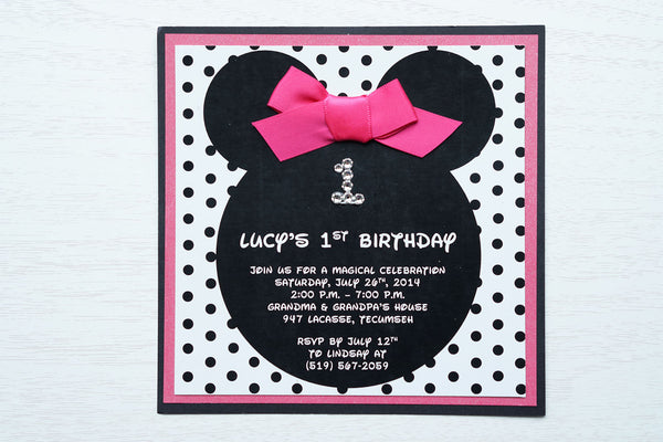 alt="Fun Disney inspired birthday party invitation features a matte white stock on hot pink pearlescent shimmer and matte black card stock layers, Minnie Mouse ears, an elegant jewel age detail, a black polka dot background and is finished off with a rich pink ribbon bow to match"