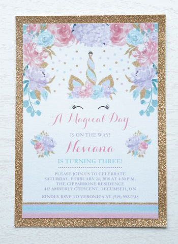 alt="Magical birthday party invitation features a white pearlescent shimmer stock on a gold glitter card stock, an elegant watercolour unicorn horn/crown and floral design in pink, purple and teal and is finished with a jewel detail on the tip of the horn"