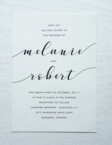 alt="Simple wedding invitation features an ivory linen matte card stock and a fun calligraphy font in black"