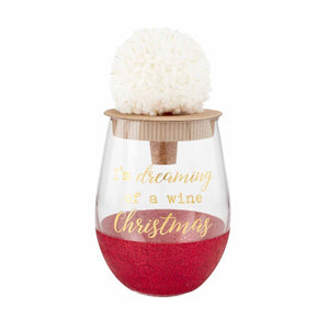 alt="Red Christmas glitter wine glass with a gold ‘I’m dreaming of a wine Christmas’ sentiment and arrives with white yarn and lurex pom cork bottle stopper"