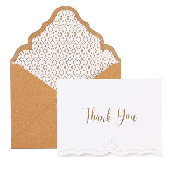alt=“These French Perle thank you note cards feature a classic and elegant design. White cards say "Thank You" in gold text with a die-cut and embossed design along the bottom. Blank interior for your personalized message. Includes 12 folded cards and 12 lined and scalloped kraft envelopes in a box”