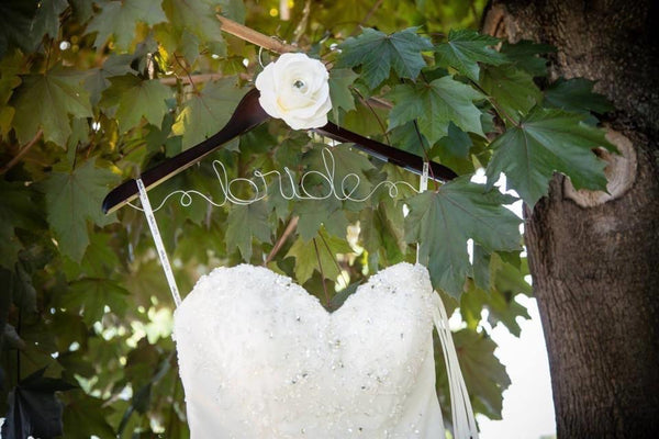 alt="Custom wood and wire bridal hanger with ivory flower detail"