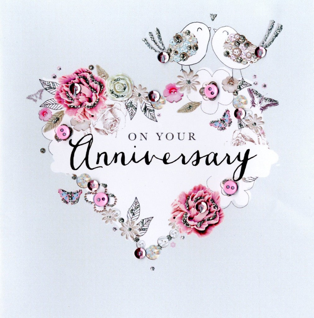 alt=“Anniversary quality hand-finished, button, sequin and glitter embellished greeting card with flowers and birds sealed in a protective wrapping complete with envelope. Message: On your Anniversary. Congratulations! Enjoy every moment on your special day”