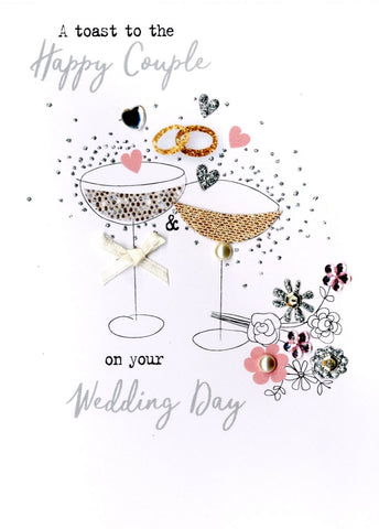 Quality hand-finished, glitter embellished greeting card by Second Nature sealed in a protective wrapping complete with envelope.  Message: ﻿A toast to the Happy Couple on your Wedding Day. Wishing you love , laughter and happily ever after!