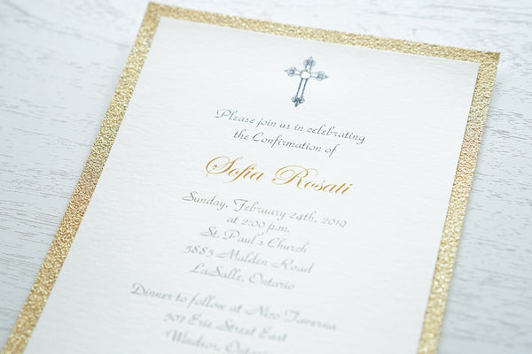 alt=“Classic Confirmation invitation features an ivory pearlescent shimmer card stock on a gold glitter card stock and an elegant cross and jewel detail”