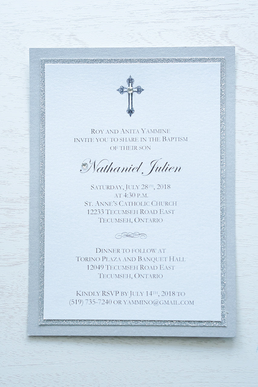 alt=“Elegant layered Baptism invitation features a white pearlescent shimmer card stock on silver glitter and silver pearlescent shimmer card stock layers finished with an elegant cross and jewel detail”