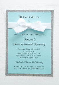 alt="Luxurious Tiffany & Co. inspired birthday invitation features a Tiffany blue pearlescent shimmer card stock on a silver glitter stock, a rich white satin ribbon bow and an elegant jewel detail"