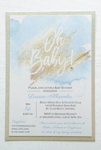 alt=“Trendy baby shower invitation features quartz pearlescent shimmer and gold glitter card stock layers and a blue and gold watercolour design with a sweet “Oh Baby!” sentiment and jewel detail”
