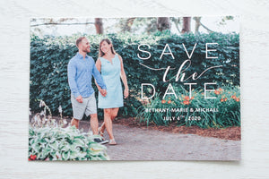 alt="Timeless photo save the date card features a photo of your choice and your names and wedding date printed on a white or ivory matte or pearlescent shimmer card stock"
