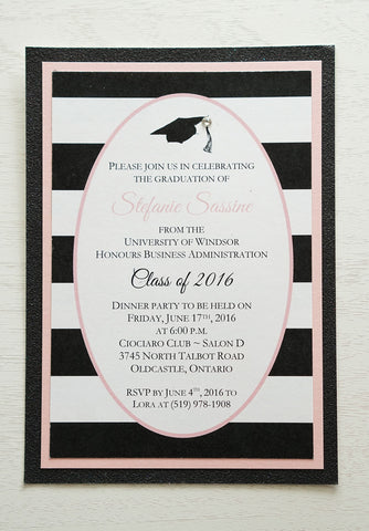 alt="Modern graduation party invitation features a matte white card stock on a pink pearlescent shimmer stock layered on a black glitter stock, a black grad cap and jewel detail and an oval design with a black and white striped pattern to finish it off"