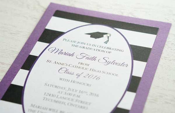 alt="Classic graduation party invitation features a matte white card stock on a purple pearlescent shimmer card stock , a black grad cap and jewel detail and an oval design with a black and white striped pattern to finish it off"