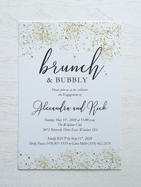 alt="Sparkling confetti engagement party invitation features a white pearlescent shimmer card stock with gold confetti and a modern script font"