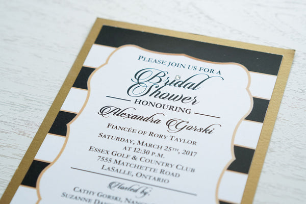 alt="Modern Bridal Shower invitation features a matte white stock on an antique gold pearlescent shimmer stock, a black and white striped background with a gold frame, a bold script font and a jewel detail to finish it off"