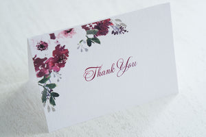 alt="Elegant thank you card features a white pearlescent shimmer card stock and a beautiful purple watercolour floral design in the top left corner"