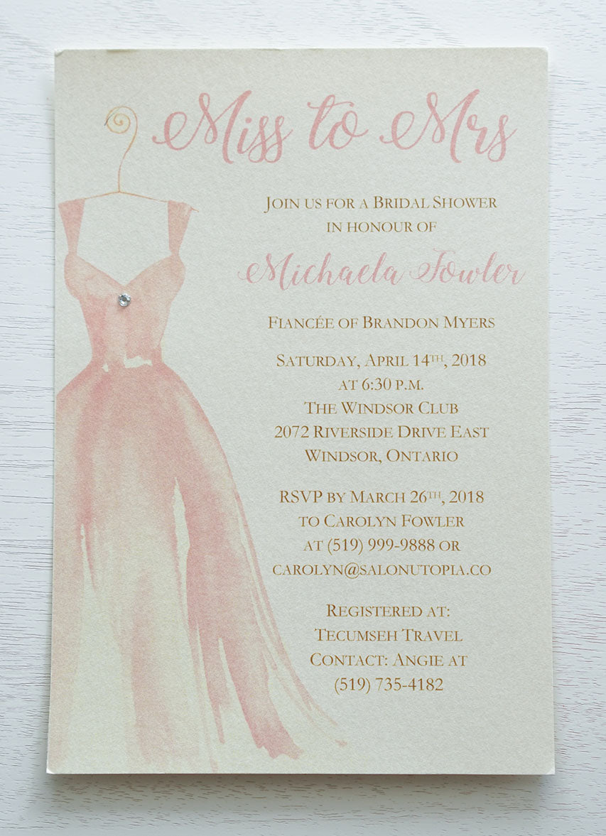 alt="Glam Bridal Shower invitation features an ivory pearlescent shimmer card stock, an elegant pink watercolour wedding dress design and a jewel detail to finish it off"