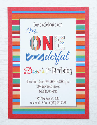 alt="Fun birthday party invitation features a matte white stock on a red pearlescent shimmer card stock, a colourful striped border and Mr. ONEderful finished with a bowtie detail"