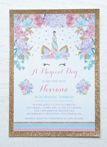 alt="Magical birthday party invitation features a white pearlescent shimmer stock on a gold glitter card stock, an elegant watercolour unicorn horn/crown and floral design in pink, purple and teal and is finished with a jewel detail on the tip of the horn"