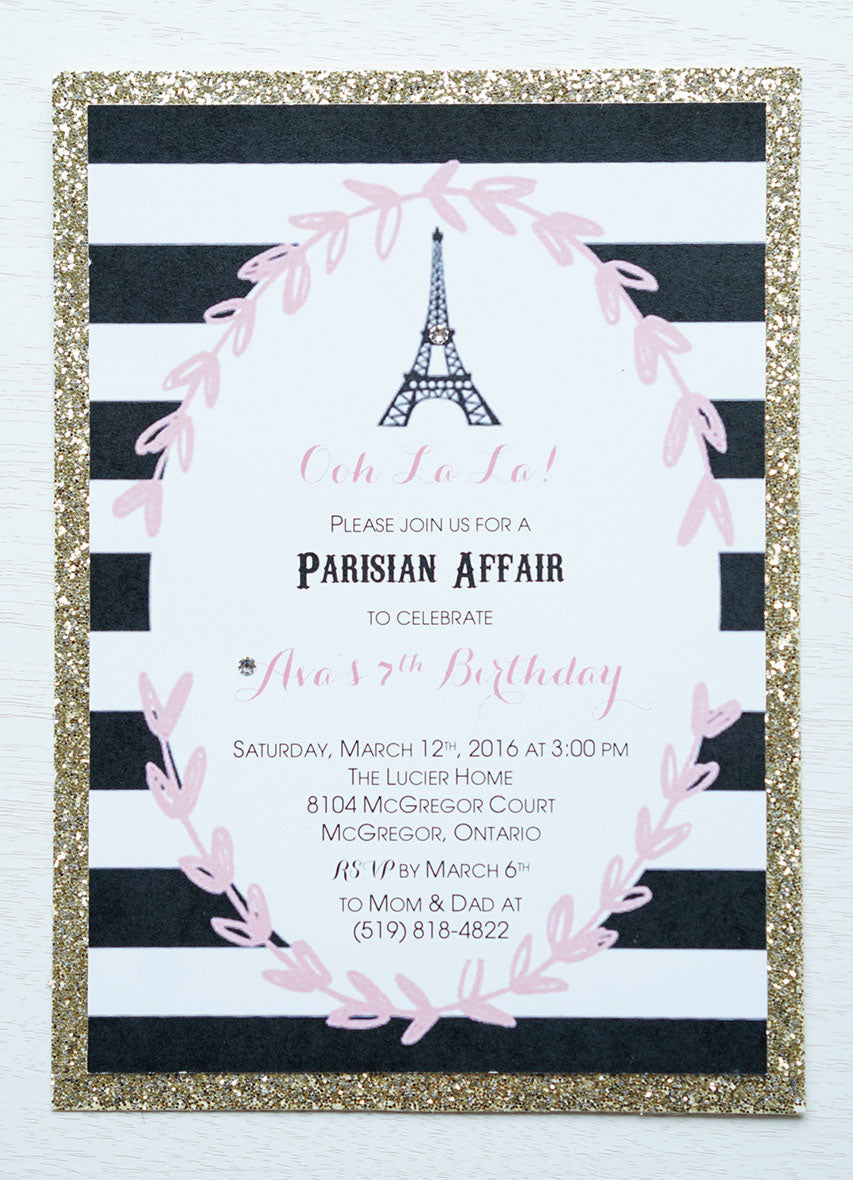 alt="Elegant Parisian birthday party invitation features a matte white stock on a gold glitter card stock, a pink floral leaf frame with a black and white striped background and is finished off with an Eiffel Tower design and jewel detail"
