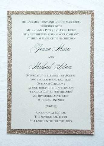 alt="Classic wedding invitation features an ivory pearlescent shimmer card stock layered onto rose gold glitter and an elegant script font"