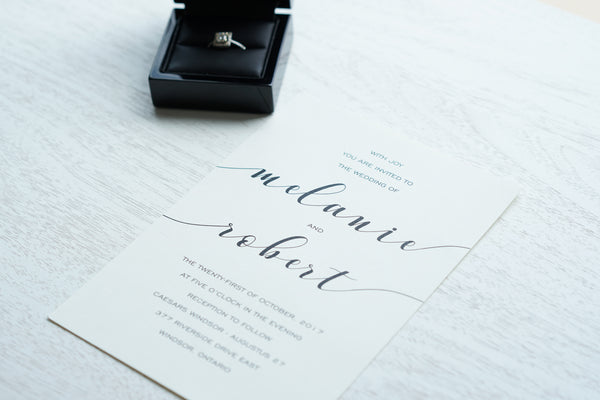 alt="Simple wedding invitation features an ivory linen matte card stock and a fun calligraphy font in black"