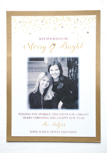 alt="This modern photo card features a white matte and antique gold pearlescent shimmer card stock, gold glitter and confetti detail at top with “May your days be Merry & Bright” printed below in gold and black writing and a photo and greeting of your choice"