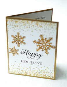 alt="This modern card features a white matte card stock on antique gold pearlescent shimmer card stock, gold glitter and confetti, gold snowflakes and “Happy Holidays” or “Merry Christmas” printed sentiment in black writing"
